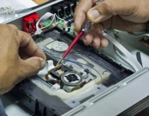 Computer repair technician working on circuit board
